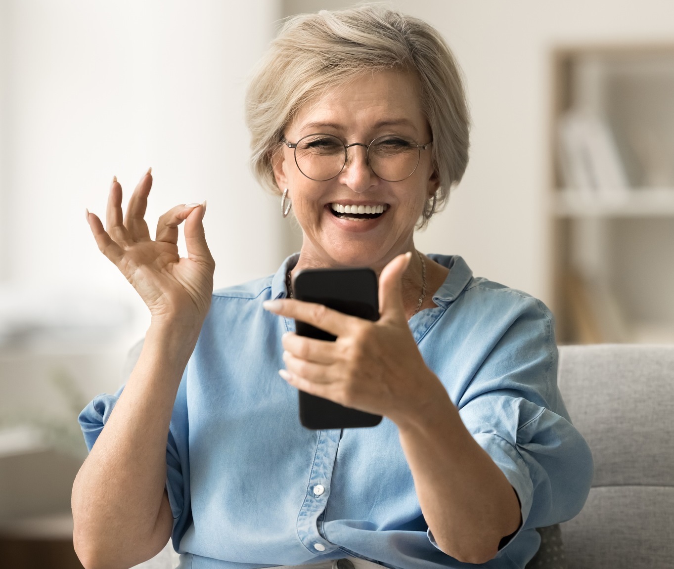 Happy senior woman using mobile phone
