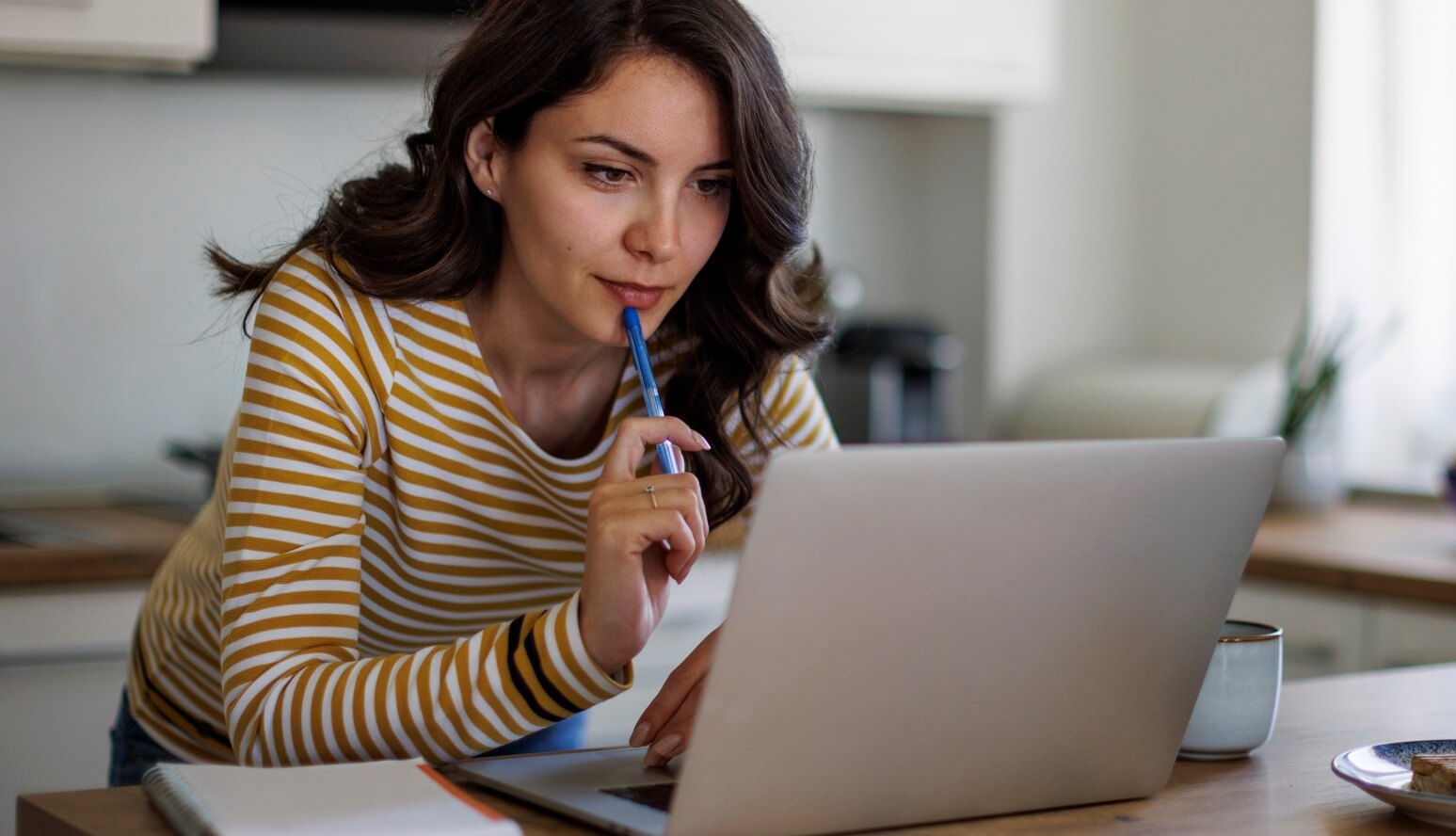 Woman researching pharmacy benefits on laptop.