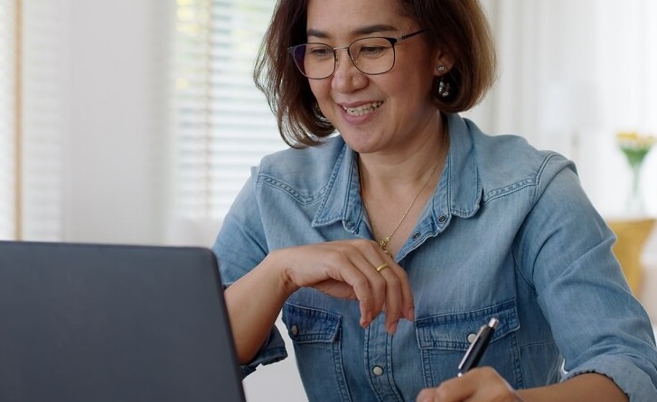 Woman using computer to look up health care information.