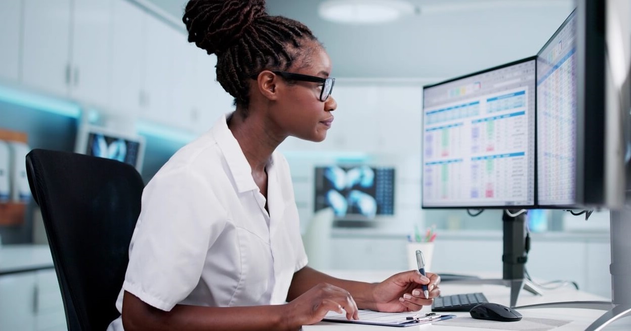 Provider office staff member working at computer.