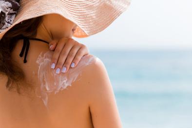 Woman Applying Sun Block