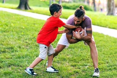 Father son playing football