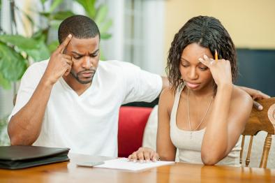 Man and woman stressing over bills