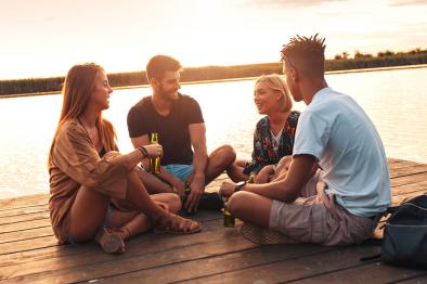 Young adults hanging out on a dock