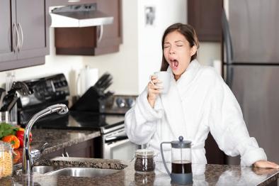 Tired woman drinking coffee in the morning