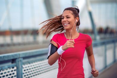a woman is jogging accross a bridge