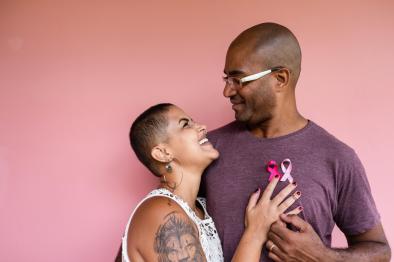 A woman looking up at a man with her hand on his heart