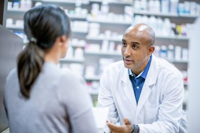 Pharmacist advising patient