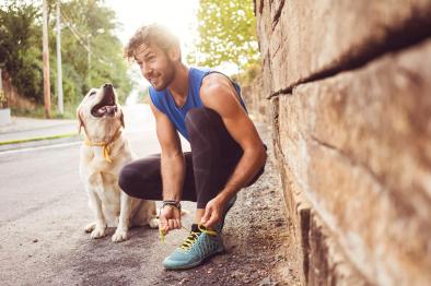 Photo of man in running gear with his dog.