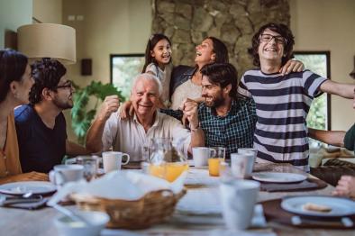 Photo of happy, multigenerational family at dinner table.