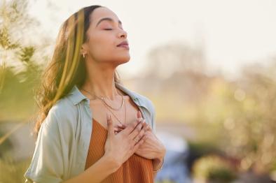 Young woman taking calm, meditative breaths.