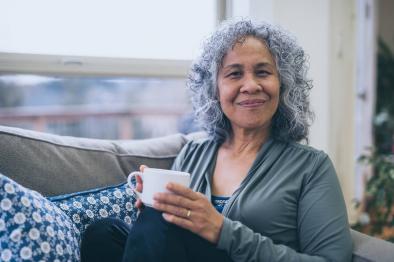 Woman looking content drinking cup of tea.