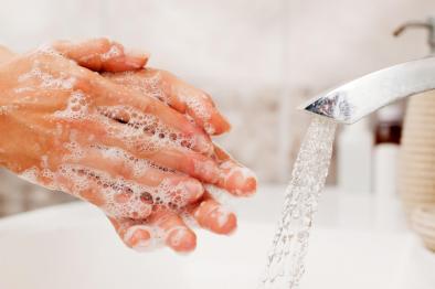 Photo of person washing hands with soap