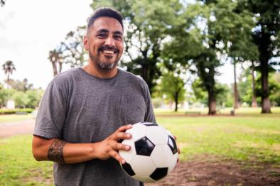 Adult man with soccer ball at park