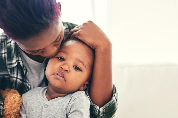 Parent holding sick child