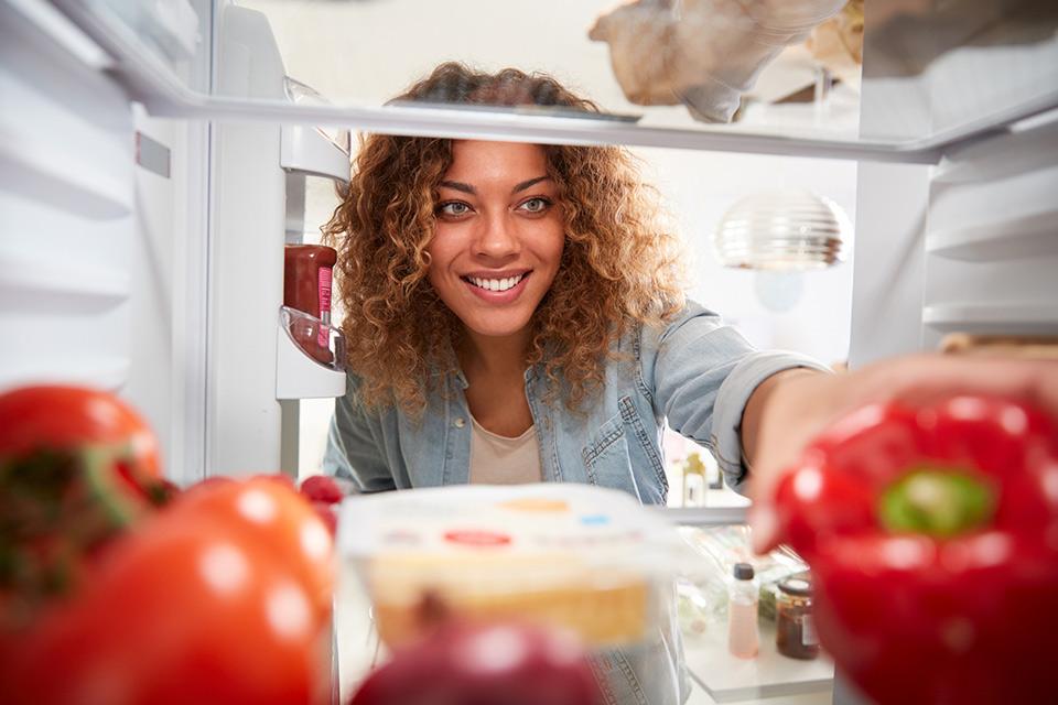 Woman Looking Inside a Fridge