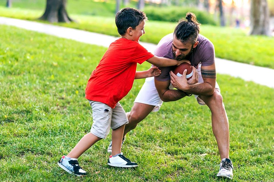 Father son playing football