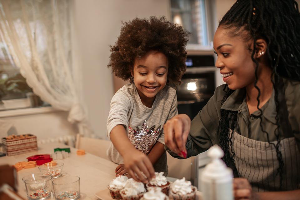 Mother and daughter making cupcakes