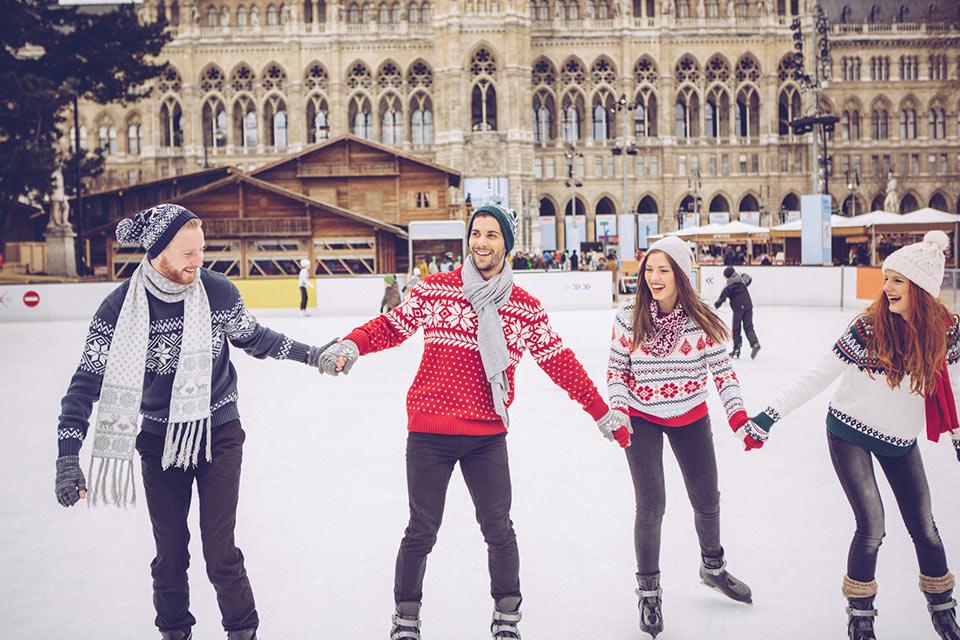 Four people ice skating
