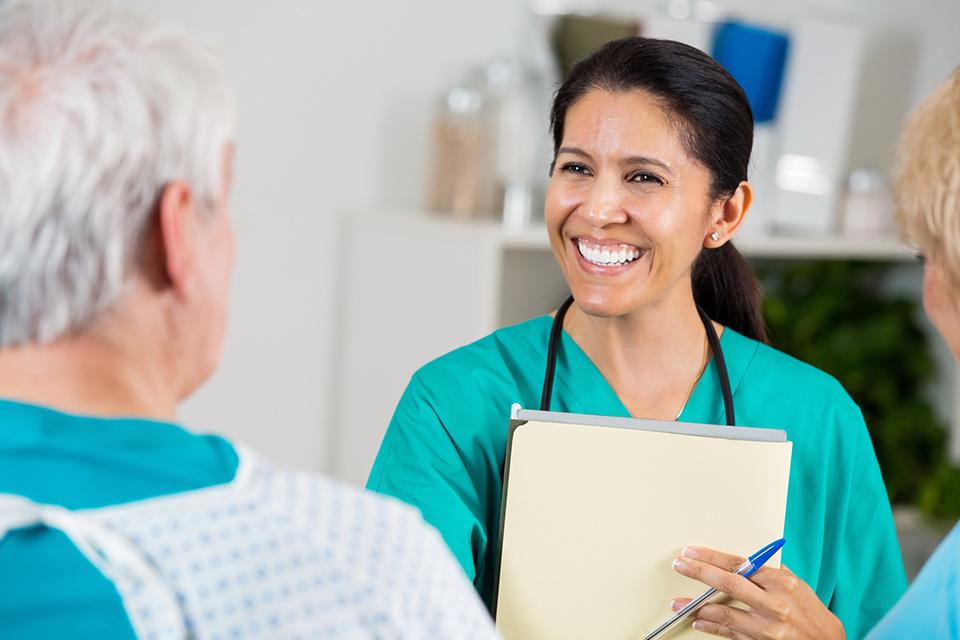 Nurse speaking with elders man