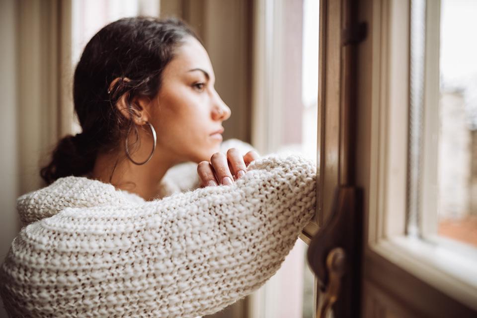 Sad woman looking out a window