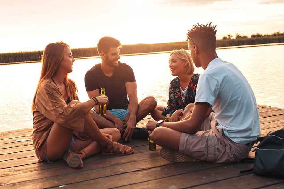 Young adults hanging out on a dock