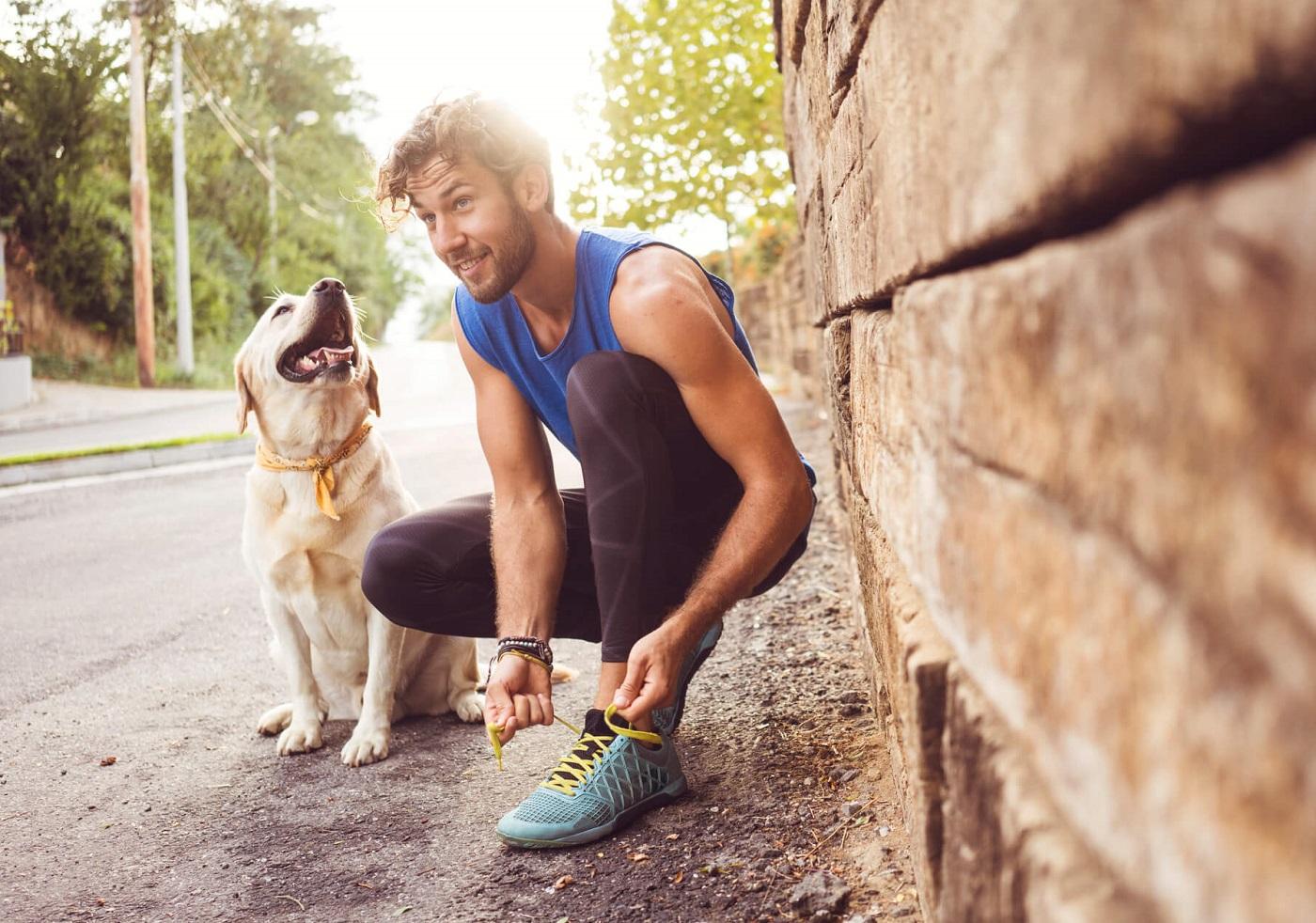 Photo of man in running gear with his dog.