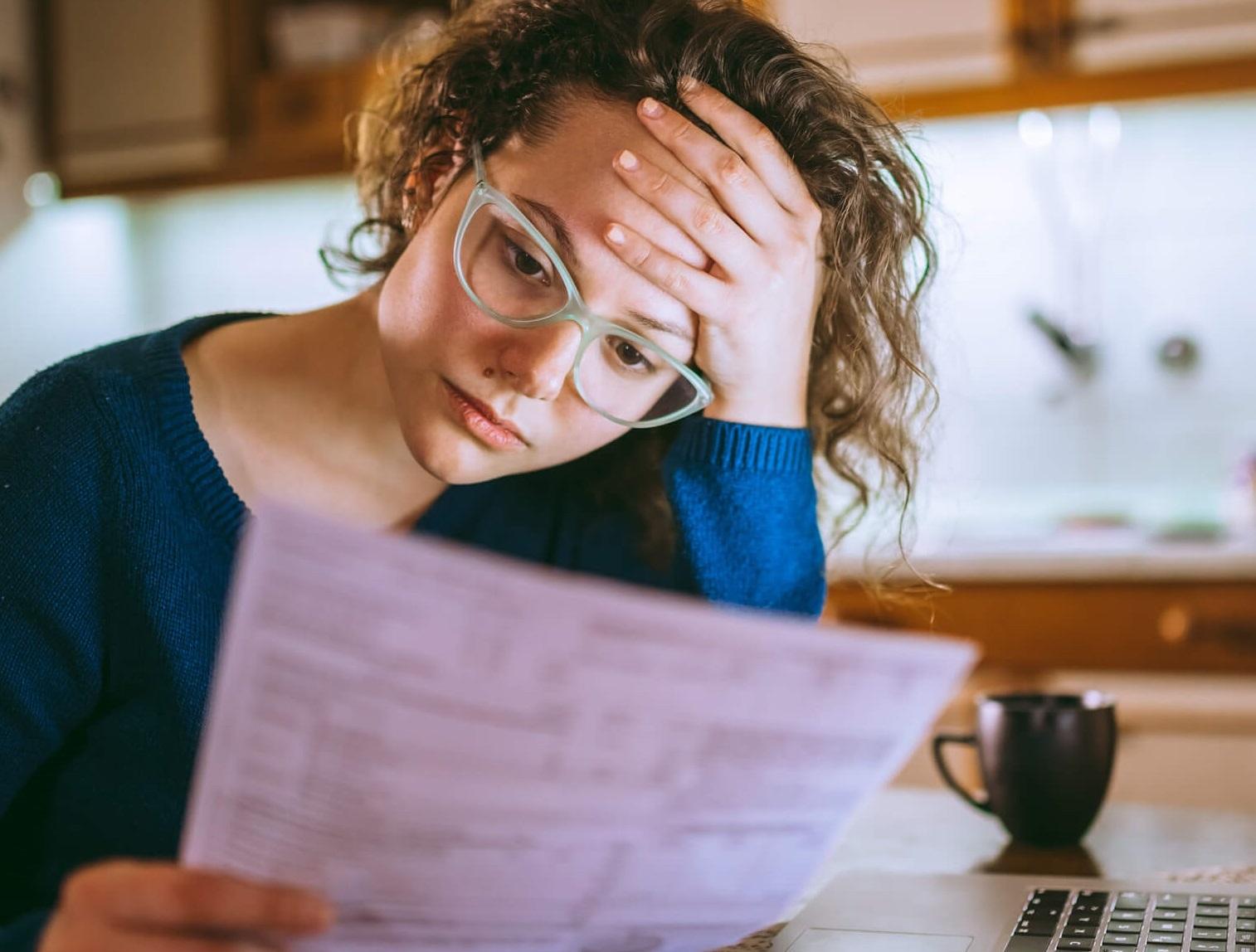 Concerned woman looking at a bill.