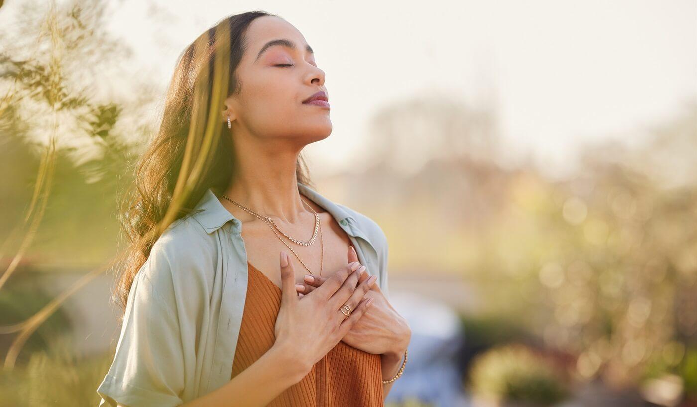 Young woman taking calm, meditative breaths.