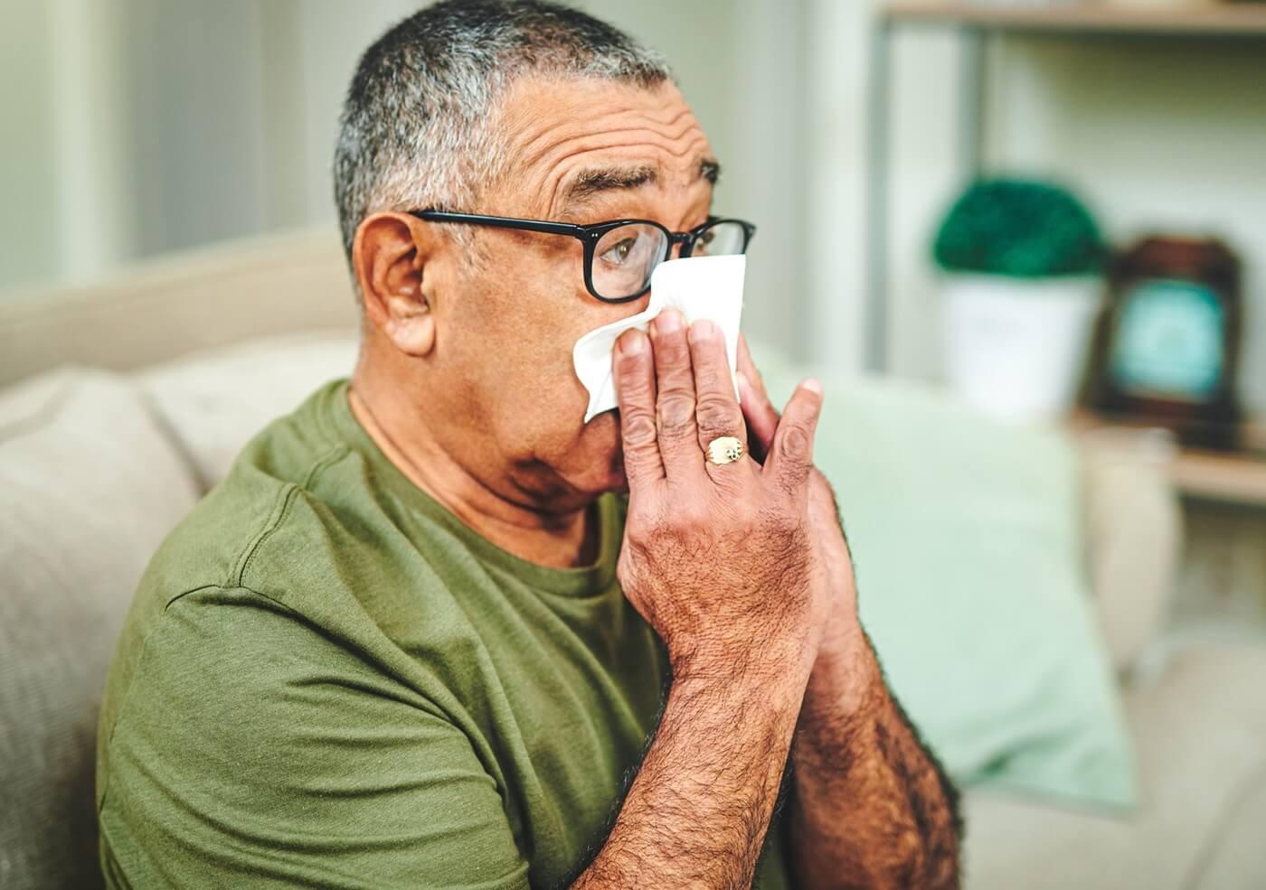 Image of middle aged man sick with the flu.