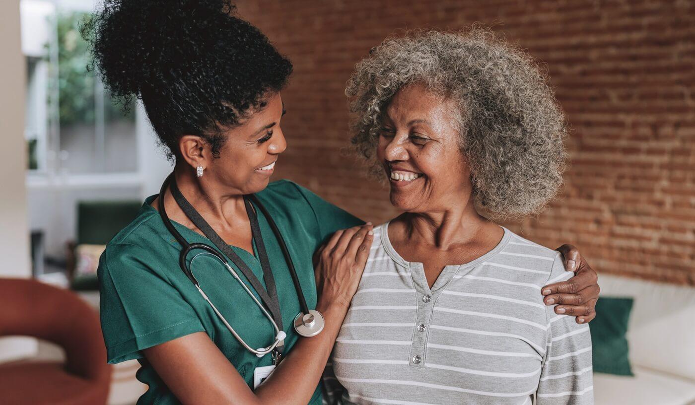Senior woman with home visit nurse